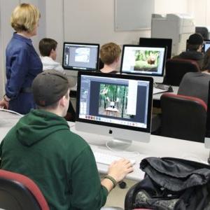 Student looking at a computer screen in a computer lab